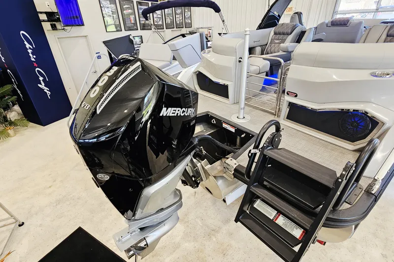 Slide: The Image of 2024 Bennington RX 23 RXFBA boat with Mercury V8 engine, showcased indoors. - 4