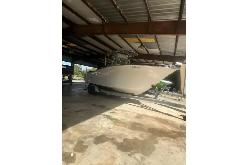 Slide: The Image of 2002 Cape Horn 27 XS boat on trailer in covered storage area. - 10