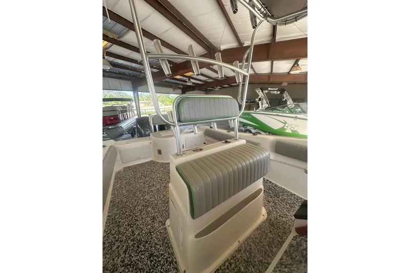 Slide: The Image of 2002 Cape Horn 27 XS boat interior with seating and storage in a covered area. - 3