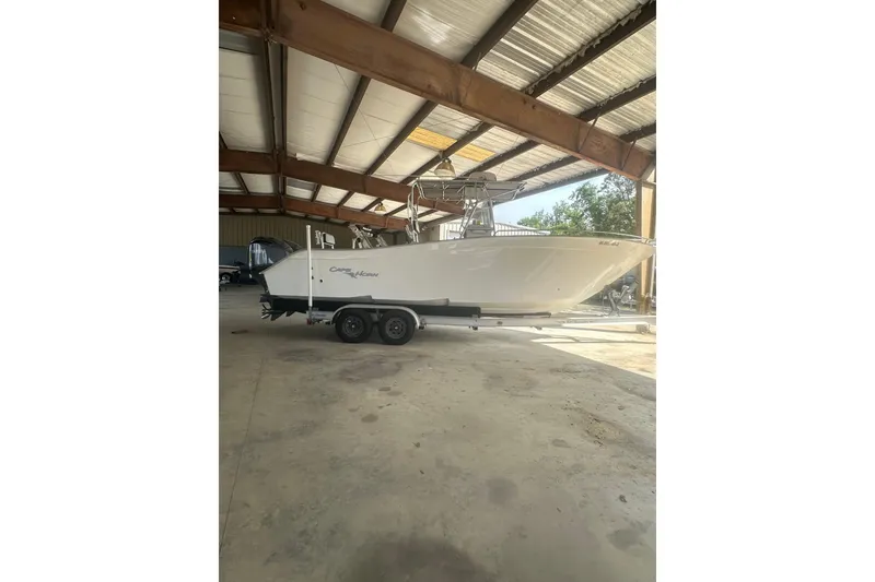 Slide: The Image of 2002 Cape Horn 27 XS boat on trailer in covered storage area. - 4