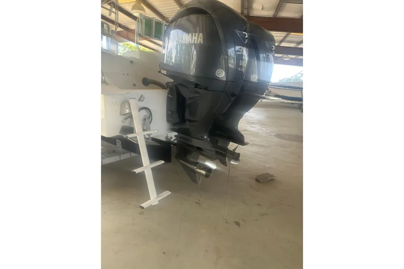 Slide: The Image of 2002 Cape Horn 27 XS boat with dual Yamaha outboard motors in a covered storage area. - 5