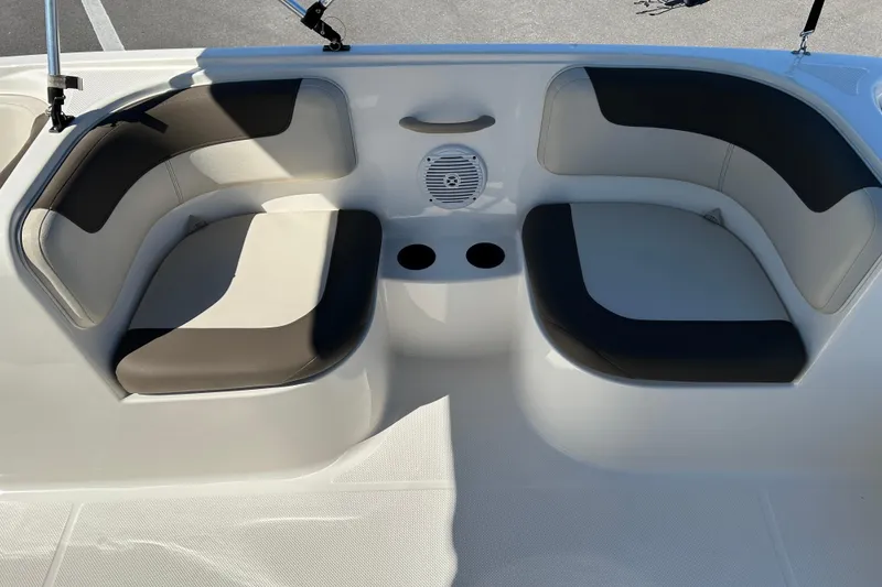 Slide: The Image of 2019 Bayliner Element E18 boat interior with cushioned seating and cup holders. - 11