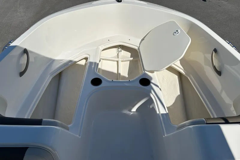 Slide: The Image of 2019 Bayliner Element E18 boat interior with seating and storage compartments. - 13