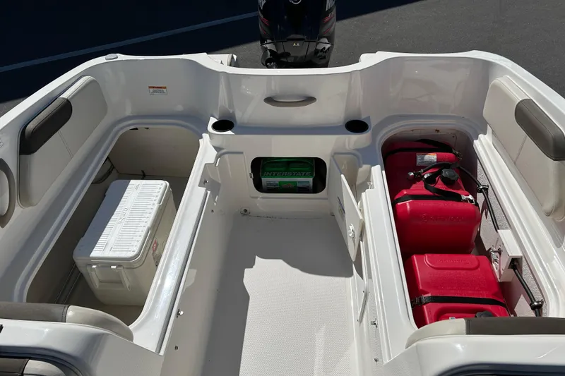 Slide: The Image of 2019 Bayliner Element E18 boat interior with storage compartments and seating. - 16
