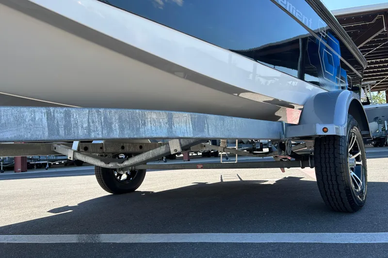 Slide: The Image of 2019 Bayliner Element E18 boat on trailer, showcasing hull and wheel details. - 17