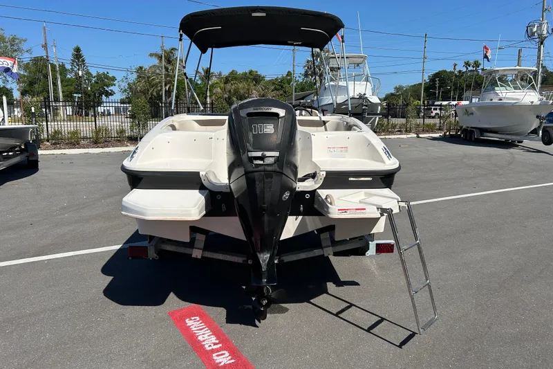 Slide: The Image of 2019 Bayliner Element E18 boat with Mercury 115 outboard motor, parked on a trailer. - 3