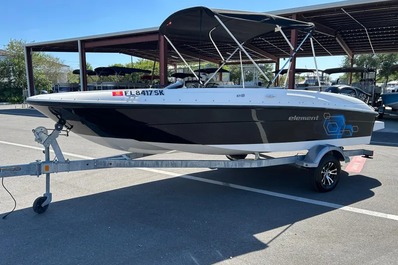 Slide: The Image of 2019 Bayliner Element E18 boat on trailer in parking lot. - 5