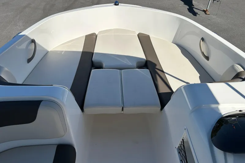 Slide: The Image of 2019 Bayliner Element E18 boat interior with cushioned seating and storage compartments. - 8