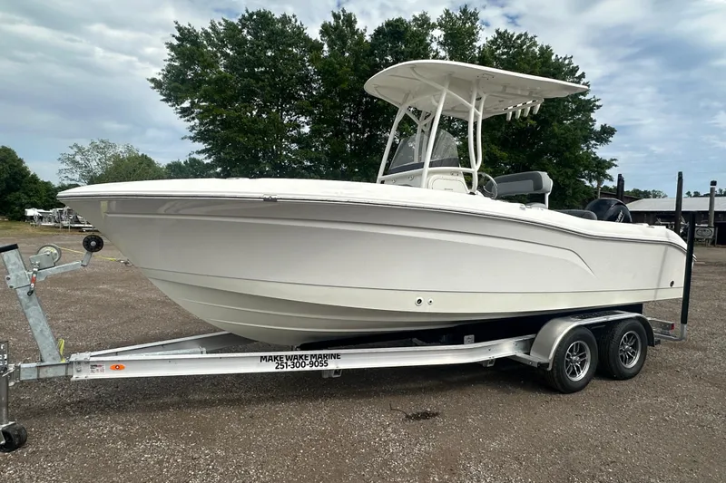 The Image of 2023 NAUTIC STAR 22 L boat on trailer, parked outdoors. - 1
