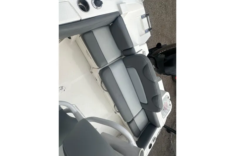 Slide: The Image of 2023 NAUTIC STAR 22 L boat interior with gray cushioned seating. - 10