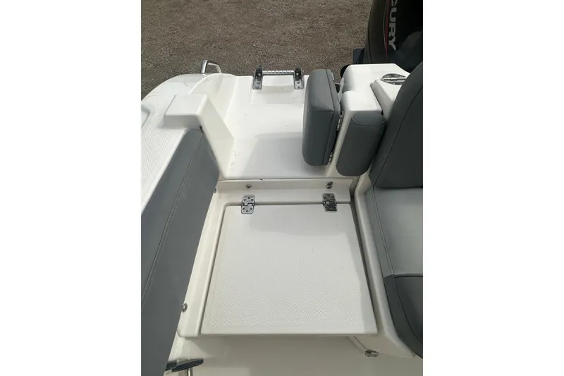 Slide: The Image of 2023 NAUTIC STAR 22 L boat interior with seating and storage compartment. - 14