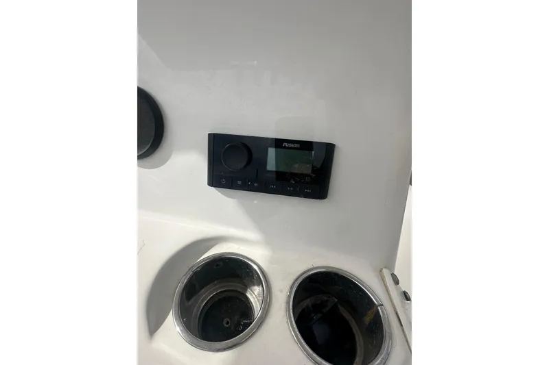Slide: The Image of Control panel and cup holders on 2023 NAUTIC STAR 22 L boat. - 17