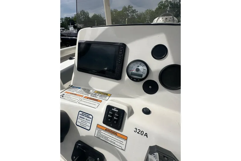 Slide: The Image of 2023 NAUTIC STAR 22 L boat dashboard with gauges and controls. - 18
