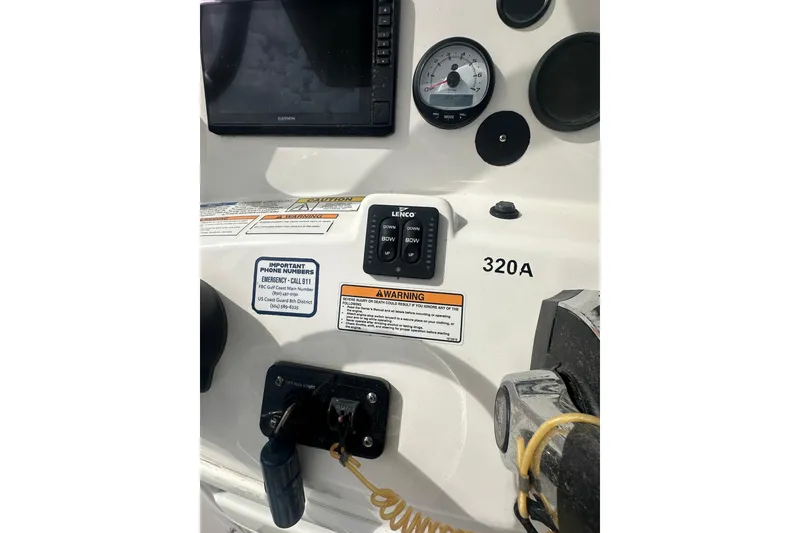 Slide: The Image of Control panel of 2023 NAUTIC STAR 22 L boat with gauges and warning labels. - 19