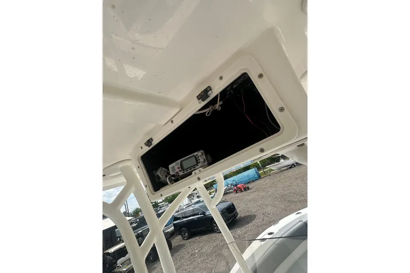 Slide: The Image of 2023 NAUTIC STAR 22 L boat console with open electronics compartment. - 20