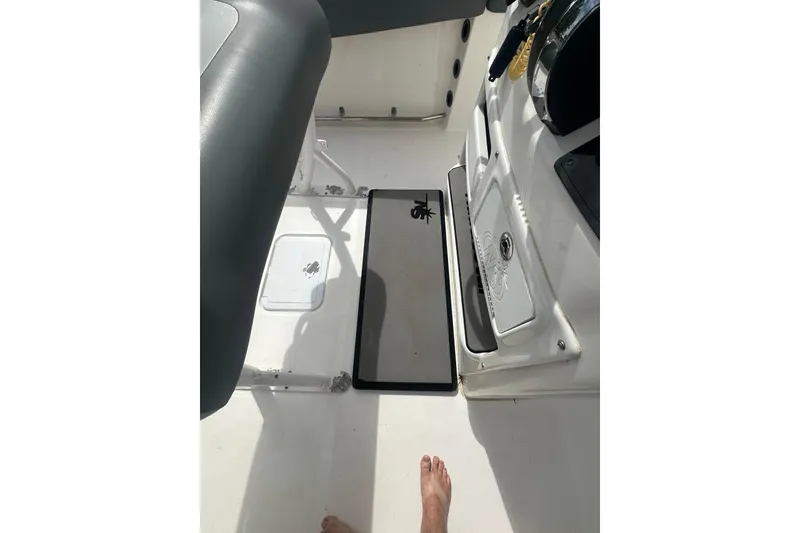 Slide: The Image of Interior view of 2023 NAUTIC STAR 22 L boat, featuring seating and storage compartments. - 21