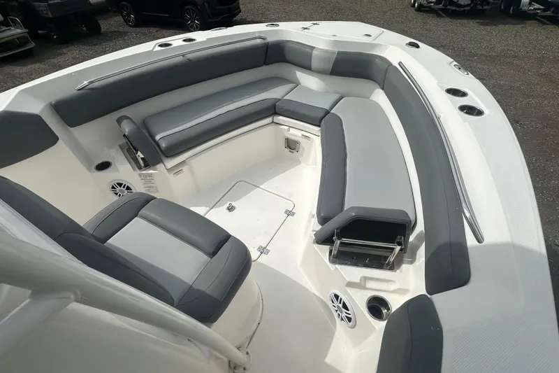 Slide: The Image of 2023 NAUTIC STAR 22 L boat interior with gray seating and cup holders. - 22