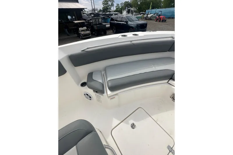 Slide: The Image of 2023 NAUTIC STAR 22 L boat interior with gray seating and storage compartments. - 25