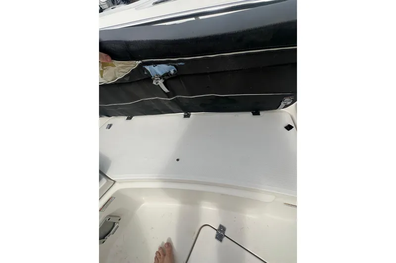 Slide: The Image of 2023 NAUTIC STAR 22 L boat interior with storage compartment open. - 28