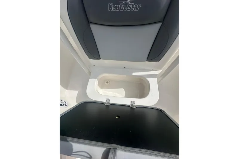 Slide: The Image of Interior view of 2023 NAUTIC STAR 22 L boat, featuring seating and storage compartment. - 34