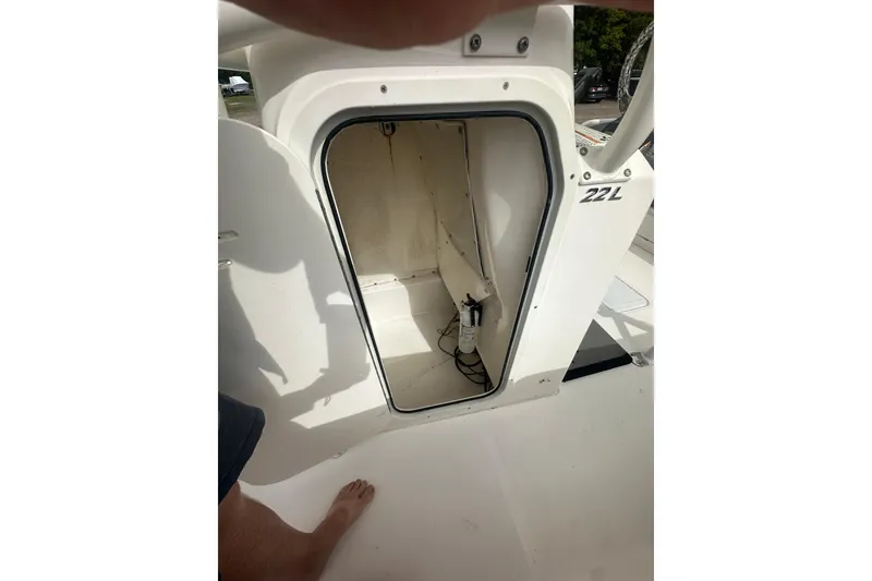 Slide: The Image of 2023 NAUTIC STAR 22 L boat storage compartment with open hatch. - 37