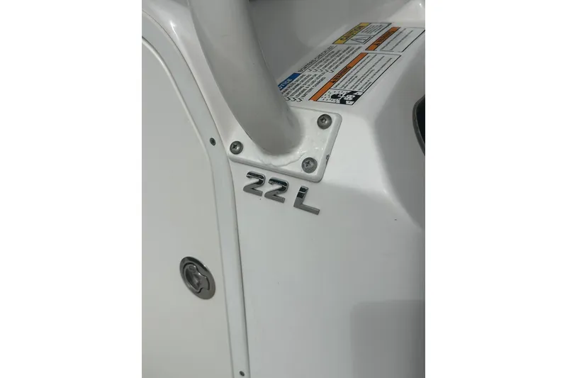 Slide: The Image of 2023 NAUTIC STAR 22 L boat detail with model emblem and safety labels. - 39