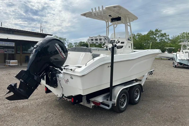 Slide: The Image of 2023 NAUTIC STAR 22 L boat with Mercury engine on trailer, parked outdoors. - 6