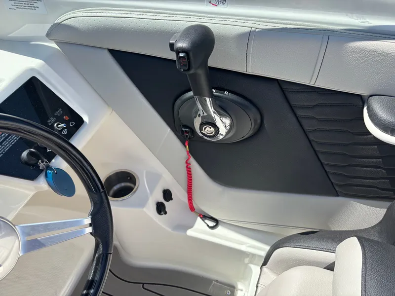 Slide: The Image of Interior of a Sea Ray SPX 190 boat, steering wheel and throttle visible. - 4