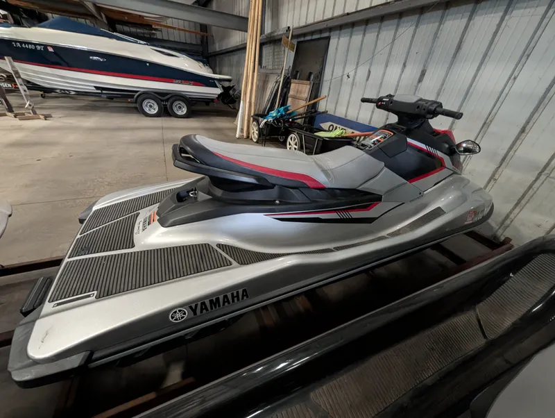 Slide: The Image of 2017 Yamaha EX1050A-SB jet ski in storage facility. - 2