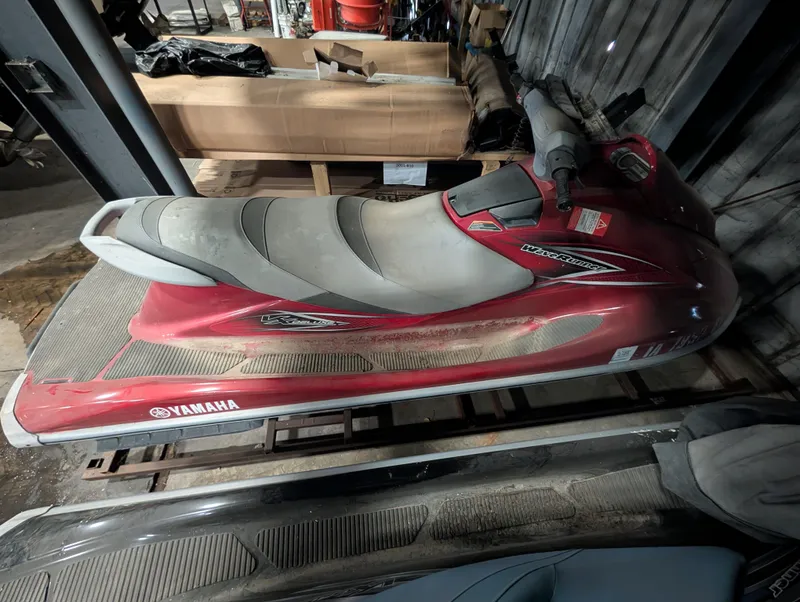 Slide: The Image of Red 2013 Yamaha VX1100B-MB jet ski in storage facility. - 2