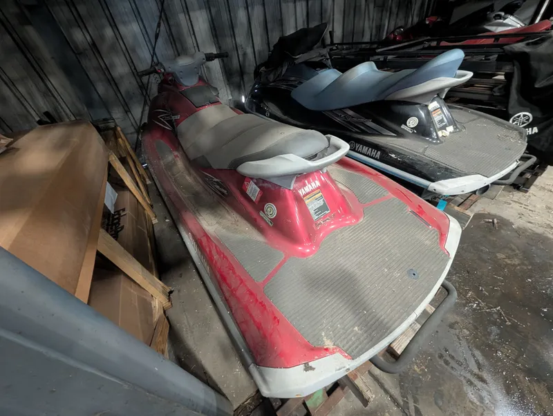 Slide: The Image of 2013 Yamaha VX1100B-MB jet ski in storage, red and gray color scheme. - 3