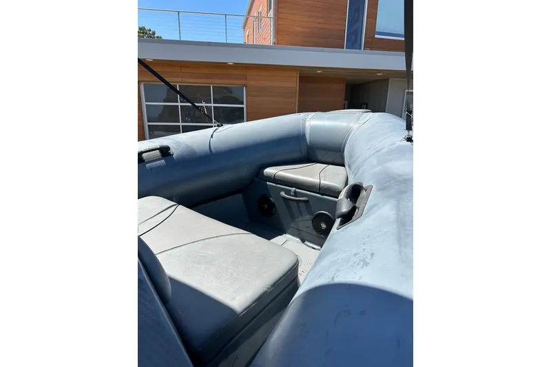 Slide: The Image of 2018 Sealegs 7.7 Amphibious RIB interior with seating, near modern building. - 14