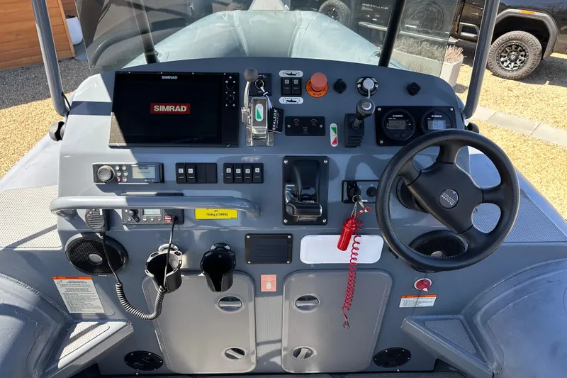Slide: The Image of Control panel of a 2018 Sealegs 7.7 Amphibious RIB with steering wheel and Simrad display. - 16