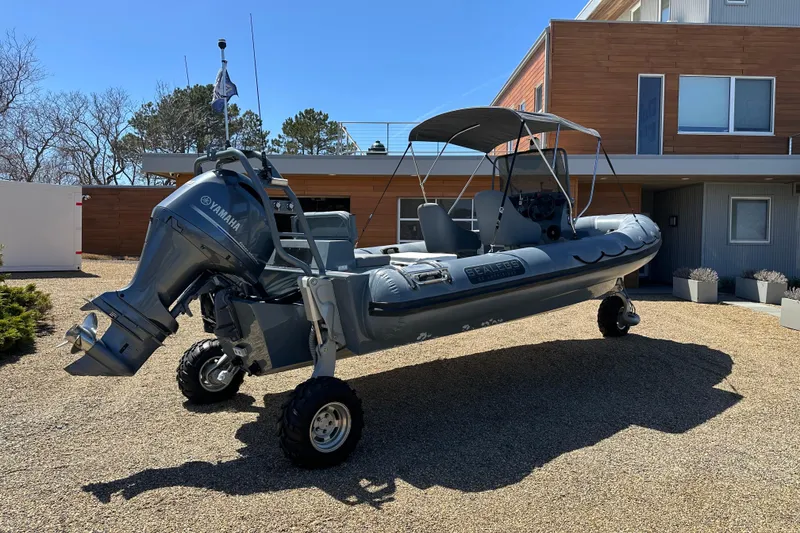 Slide: The Image of 2018 Sealegs 7.7 Amphibious RIB with Yamaha engine parked on gravel driveway. - 8