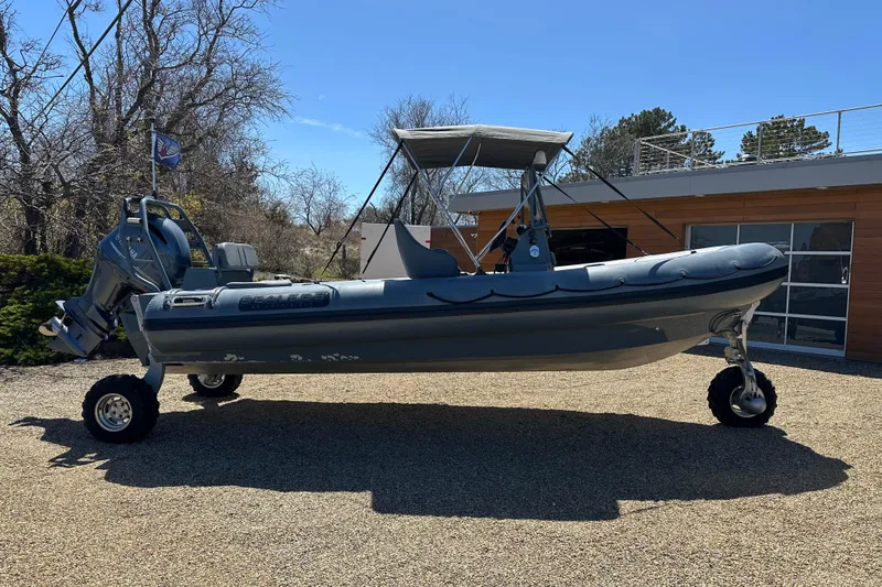 Slide: The Image of 2018 Sealegs 7.7 Amphibious RIB with wheels, parked on gravel, under clear blue sky. - 9