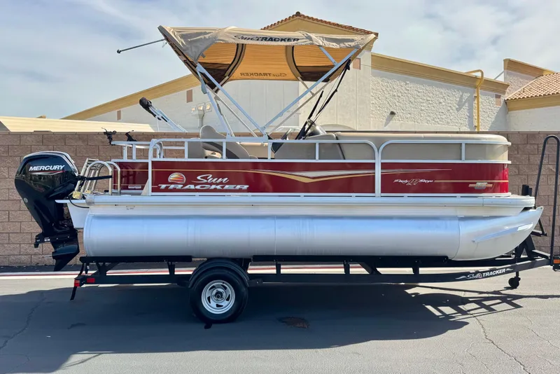The Image of 2023 Sun Tracker Party Barge 18 DLX pontoon boat with Mercury engine on trailer. - 0