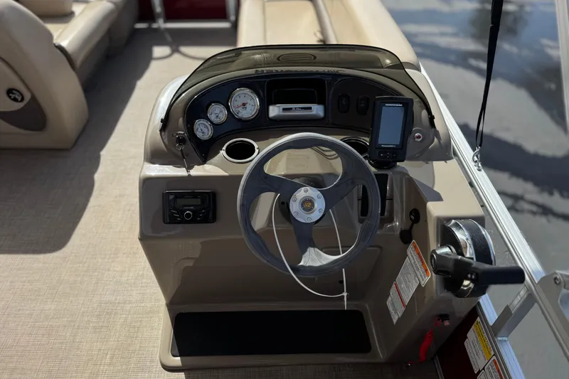Slide: The Image of 2023 Sun Tracker Party Barge 18 DLX steering console with gauges and controls. - 22