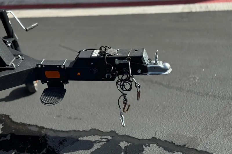 Slide: The Image of Trailer hitch of 2023 Sun Tracker Party Barge 18 DLX on asphalt surface. - 26