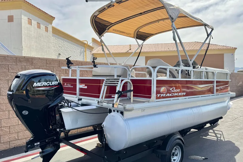 Slide: The Image of 2023 Sun Tracker Party Barge 18 DLX pontoon boat with Mercury engine, parked outdoors. - 6