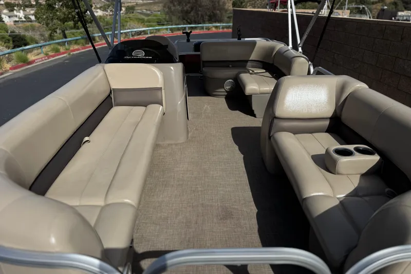 Slide: The Image of 2023 Sun Tracker Party Barge 18 DLX interior with spacious seating and cup holders. - 9