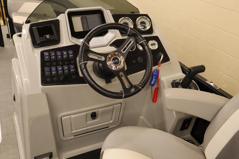 Slide: The Image of 2024 SunChaser Eclipse 8525 LR DH boat dashboard with steering wheel and control panel. - 10