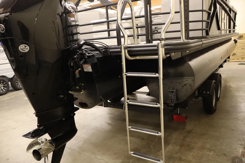 Slide: The Image of 2024 SunChaser Eclipse 8525 LR DH pontoon boat with ladder and outboard motor in a garage. - 3