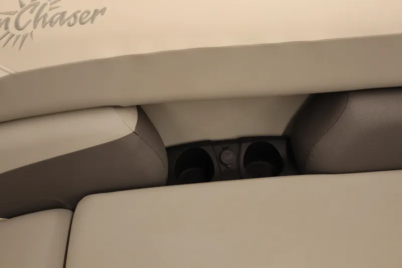 Slide: The Image of 2024 SunChaser Eclipse 8525 LR DH boat interior with cup holders and beige upholstery. - 8