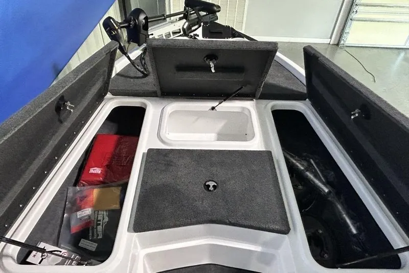 Slide: The Image of 2026 Skeeter ZX150 boat storage compartments with open lids, showcasing organized interior space. - 10