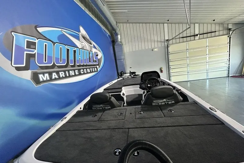 Slide: The Image of 2026 Skeeter ZX150 boat at Foothills Marine Center showroom. - 11