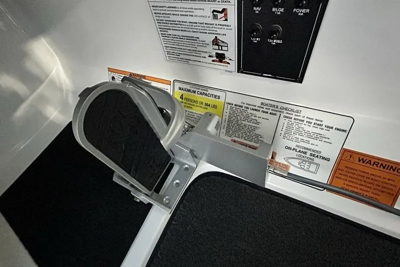Slide: The Image of Control panel and safety instructions on 2026 Skeeter ZX150 boat. - 12