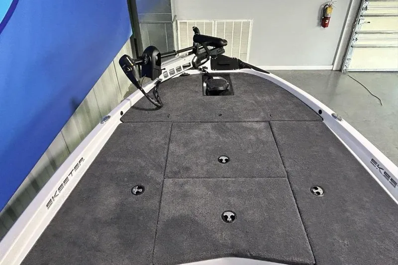 Slide: The Image of 2026 Skeeter ZX150 boat deck with carpeted surface and mounted trolling motor. - 18