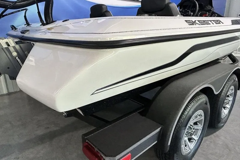 Slide: The Image of 2026 Skeeter ZX150 boat on trailer, showcasing sleek design and dual wheels. - 4