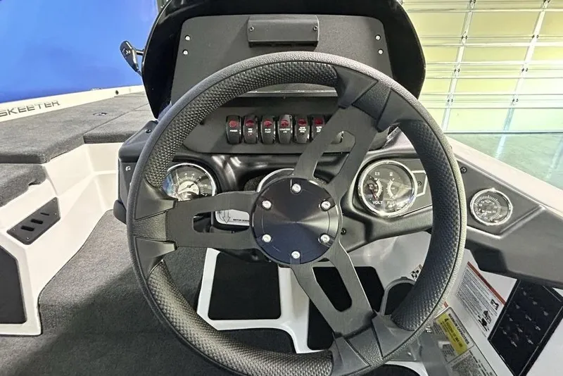 Slide: The Image of Steering wheel and dashboard of 2026 Skeeter ZX150 boat, featuring gauges and controls. - 7