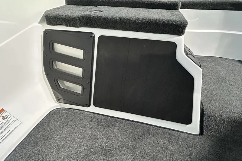 Slide: The Image of Interior view of 2026 Skeeter ZX150 boat with carpeted flooring and storage compartment. - 8
